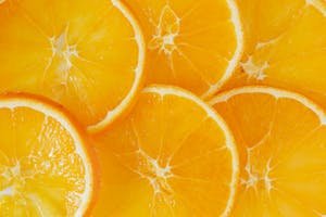 Close-up of vibrant and fresh orange slices showcasing juicy texture and color.